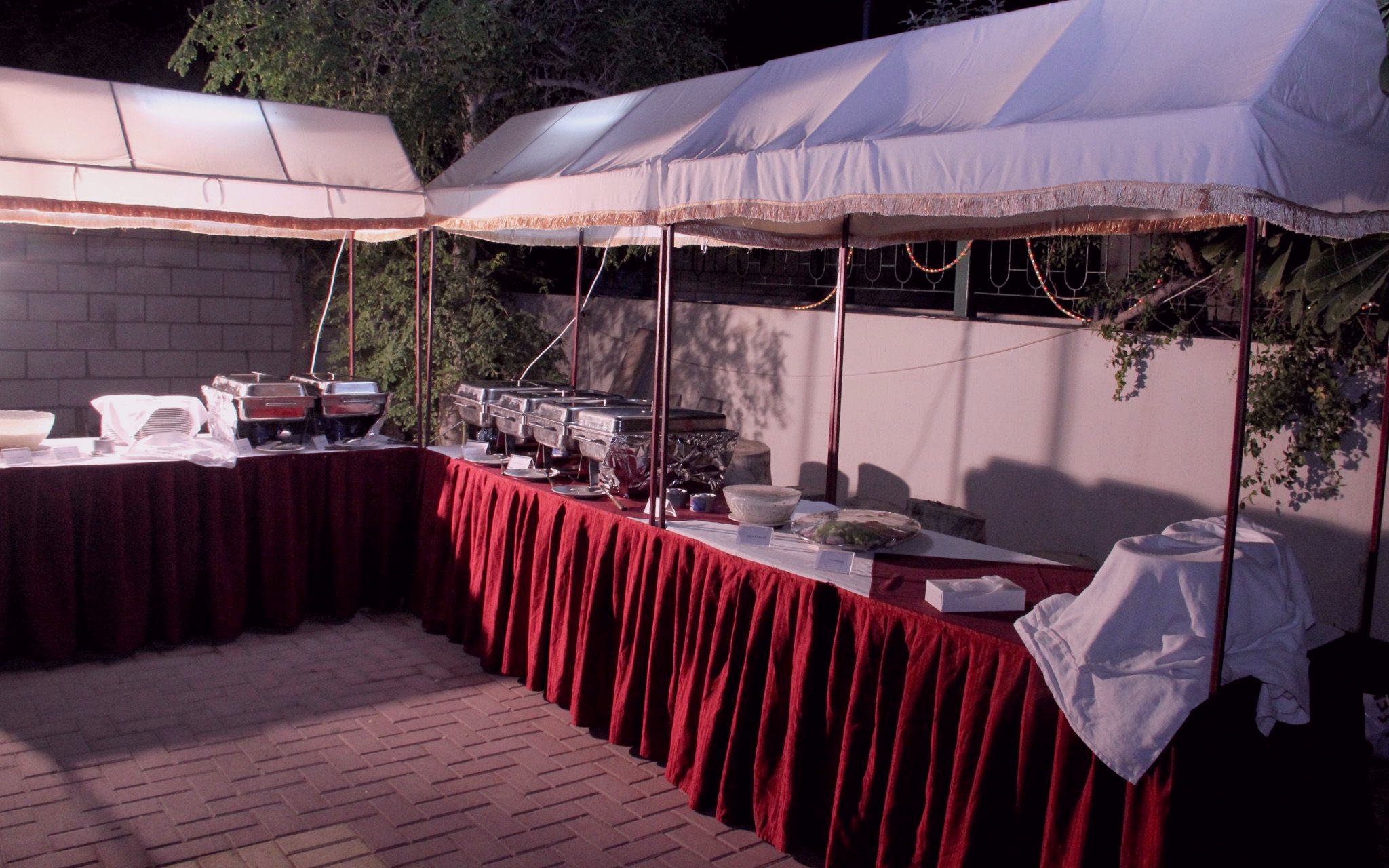 A photo of an outdoor buffet set up on nice, draped tables
